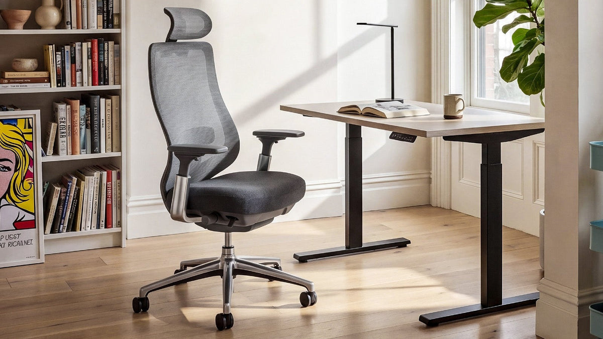 COLAMY ATLAS mesh office chair beside a wooden desk in a sunlit home workspace