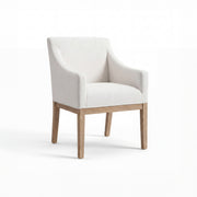An upholstered accent chair with a light beige fabric seat and backrest, curved arms, and a natural light wood frame and legs, shown on a white studio background.