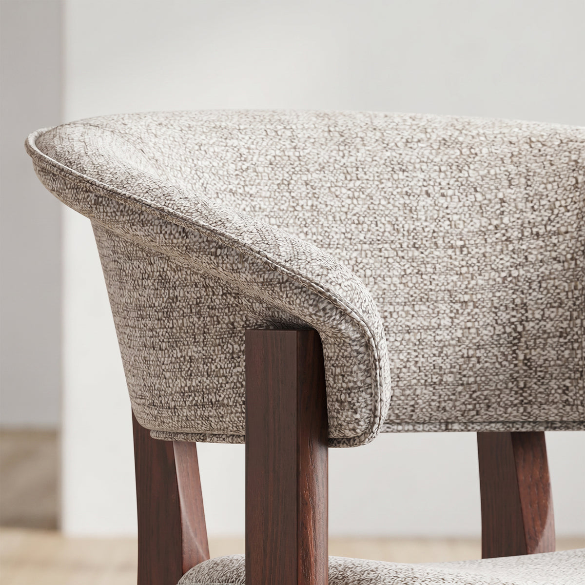 Close-up of the curved upholstered backrest on the COLAMY HALO Luxe dining chair